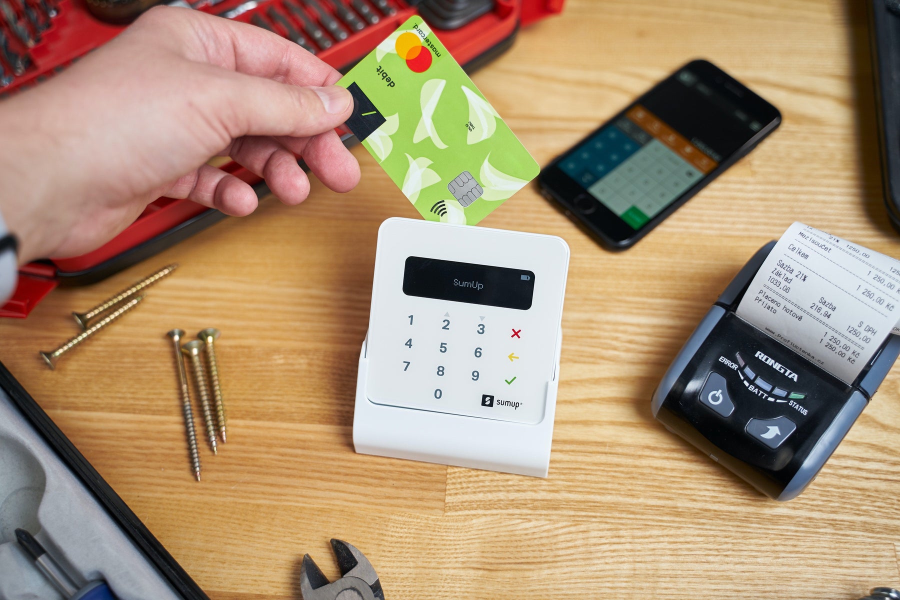 Why Should You Buy from Wireless Place Instead of a Big Box Retailer? - A Man's Hand Sliding a Credit Card Through a CRIND Machine