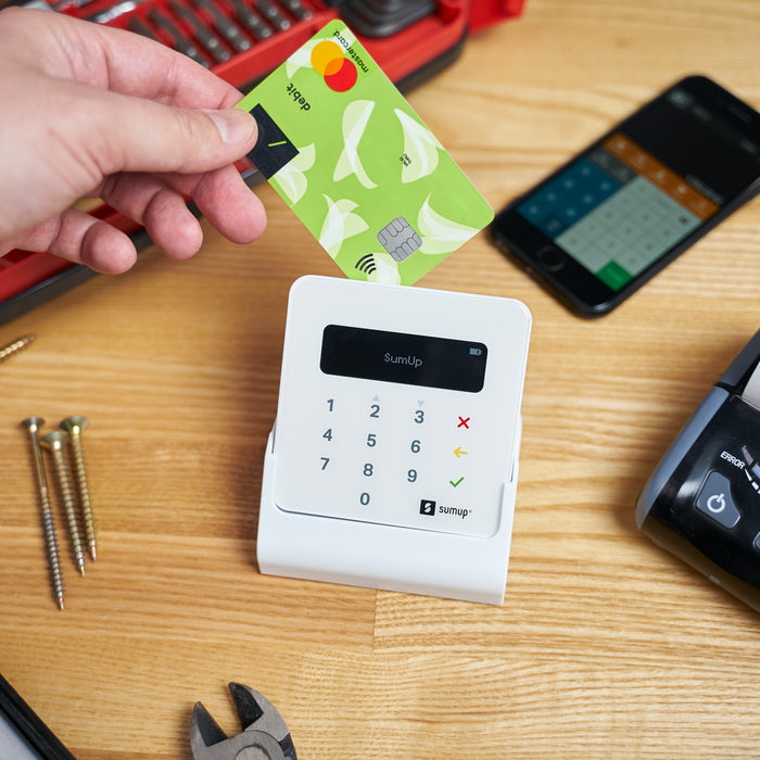 Why Should You Buy from Wireless Place Instead of a Big Box Retailer? - A Man's Hand Sliding a Credit Card Through a CRIND Machine